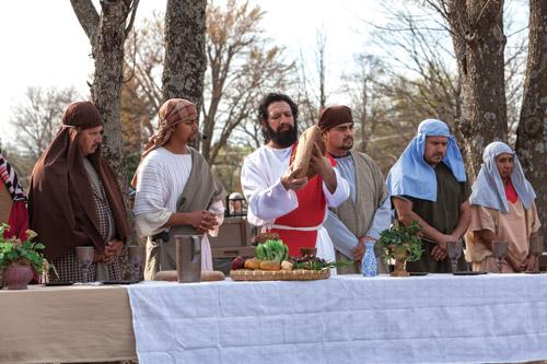 Jesus, portrayed by Rafael Pantoja, breaks bread during the Last Supper reenactment by the theater ministry of St. Vincent de Paul Church in Rogers. Living Stations of the Cross has been a Good Friday tradition at the parish for many years. (Paul Dufford photo)