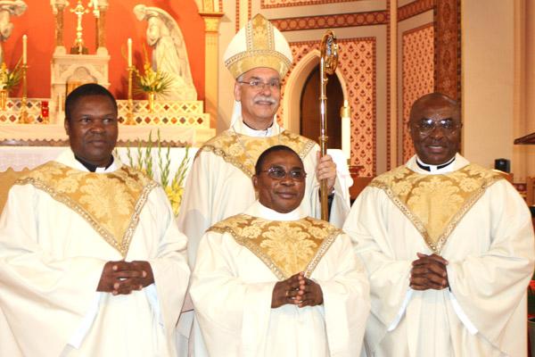 Bishop Taylor stands with the three jubilarians, Father Mallanga, Father Okeke and Father Okeiyi, after the Jubliee Mass June 27. (Aprille Hanson photo)