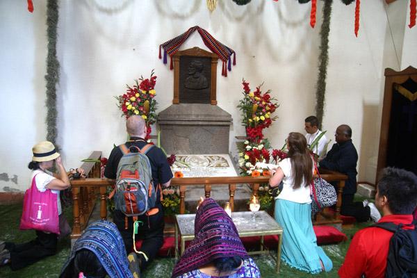 Pilgrims and local people pray at the shrine with Father Rother’s heart near the entrance of St. James Church in Santiago Atitlan. 