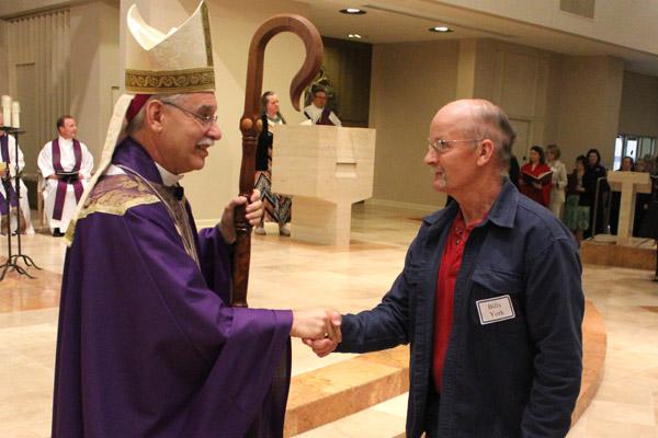 Bishop Anthony B. Taylor greets catechumen Bill York of St. Joseph Church in Conway. (Dwain Hebda photo)