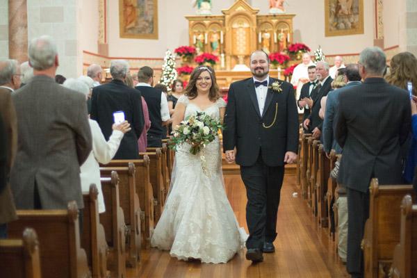 Seth and Alex Baldwin walk down the aisle after saying ‘I do’ at St. Mary Church in Altus on New Year’s Eve 2016. They said open discussion about faith and values is important. (Paxton Goates Photography)