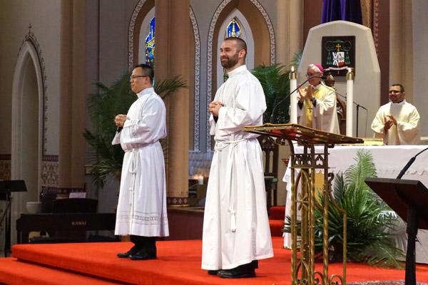 Bishop Anthony B. Taylor introduces Deacon Tuyen Do (left) and Deacon Jeff Hebert during the rite of ordination at the Cathedral of St. Andrew in Little Rock on April 8.  (Aprille Hanson photo)