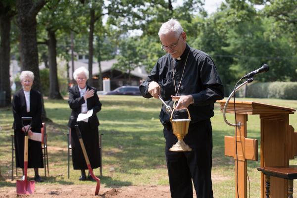 Bishop Taylor blesses the monastery ground with holy water.