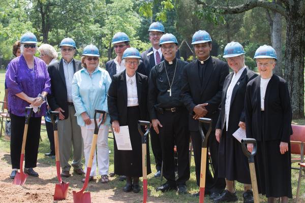 Sisters, clergy and laity participate in the groundbreaking ceremony. 