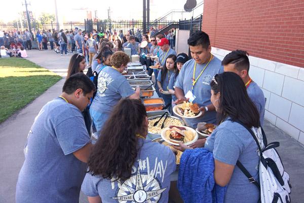 Teens attending the Catholic Youth Convention fill their plates during the Arkansas Travelers game at Dickey Stephens Park in North Little Rock May 13. (Aprille Hanson)