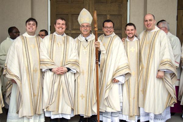 Bishop Anthony B. Taylor smiles with Fathers Luke Womack, Martin Siebold, Ramsés Mendieta, Stephen Hart and William Burmester after their ordi-nation May 27 at Christ the King Church in Little Rock. (Travis McAfee photo)