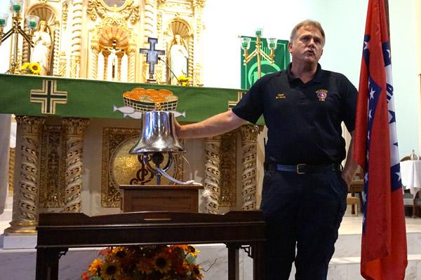Hot Springs Fire Department Chief Ed Davis explains the significance of ringing the firehouse bell, a tradition for firefighters who have died. Davis rang the bell for the first responders killed on Sept. 11, 2001. (Aprille Hanson photo)  