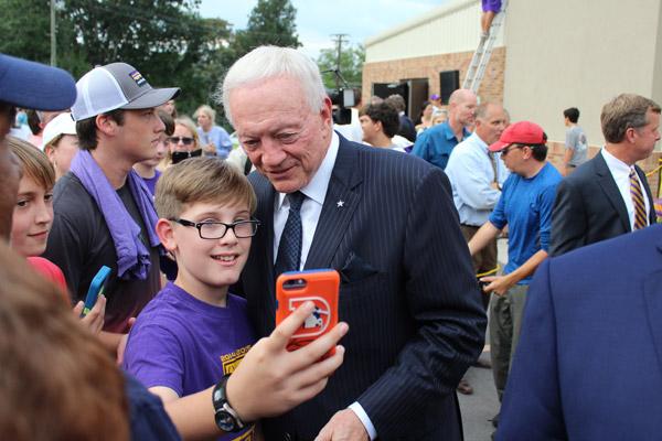 Jerry Jones poses for a selfie with a young Rocket booster following dedication ceremonies of the new Gene and Jerry Jones Family Academic and Athletic Annex at Catholic High School Aug. 30. (Dwain Hebda photo)