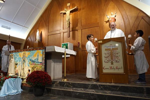 Father Paul Worm, pastor of Our Lady of Fatima Church in Benton, reads the Gospel Oct. 13 during Mass to mark the centennial of the Virgin Mary’s appearance at Fatima, Portugal. (Aprille Hanson)