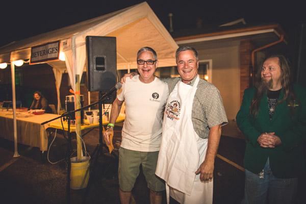Tom Maddock (left) presents Frank Ray with the champion of chili apron. This is Frank's second time to win the chili event. (Travis McAfee photo)