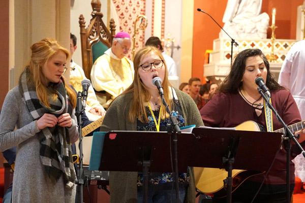 Susej Thompson (right), music director of Our Lady of the Holy Souls Church in Little Rock, leads music during the Mass for Life for youth. (Malea Hargett) 
