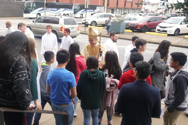 Bishop Taylor greets teens after Mass. Seminarians participated in the Mass as altar servers. (Malea Hargett)