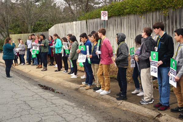 Teens from Fort Smith, Barling, Booneville and Mountain Home pray in front of the abortion clinic in Little Rock following the youth Mass. (Malea Hargett) 