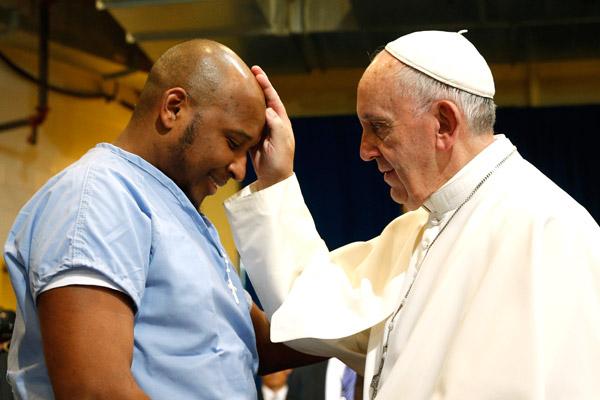 Pope Francis blesses a prisoner as he visits the Curran-Fromhold Correctional Facility in Philadelphia in this Sept. 27, 2015, file photo. (CNS / Paul Haring)