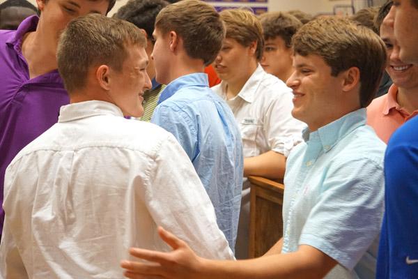 Joseph Jones smiles as he’s greeted by classmates during signing day, May 1. Jones and Thomas DePrez will live at the House of Formation and study at the University of Arkansas at Little Rock. (Aprille Hanson photo)
