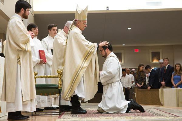 Bishop Taylor lays his hands on Father Stephen Elser to receive the strength of the Holy Spirit. (Bob Ocken)