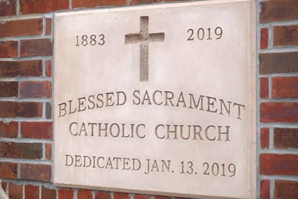 The new cornerstone to the right of the entrance shows the dedication date of Blessed Sacrament. The old parish’s cornerstone was placed to the left of the doors. (Aprille Hanson photo) 