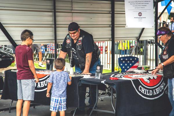 Various organizations like Bikers Against Child Abuse hosted booths during Summerfest in Springdale Aug. 18. (Travis McAfee photo)
