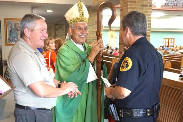 Bishop Anthony B. Taylor talks with Conway Police Chief Jody Spradlin before the Blue Mass honoring first responders Sept. 11 at St. Joseph Church in Conway. (Aprille Hanson photo)