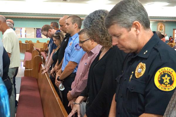 Conway Police Chief Jody Spradlin (right) bows his head in prayer, along with other first responders: David Batt (left), Mayflower Volunteer Fire Department; Kayla Evans, Medtech Morrilton; Maj. Clay Smith, Conway Police Department; Cole Breeding, Maumelle Fire Department; Lt. Bruce Childers, Conway PD; and Maj. Laura Taylor, Conway PD. (Aprille Hanson photo)