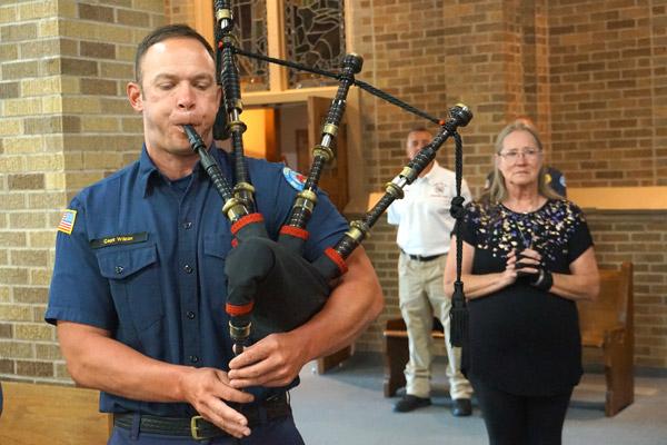 Conway Fire Department Captain Stewart Wilcox played the bagpipe to begin and close the Blue Mass at St. Joseph Church. Donna Saldana (right), a parishioner at St. Joseph, organized the Blue Mass honoring first responders. (Aprille Hanson photo)