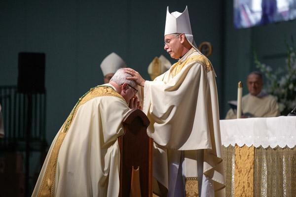 Bishop Anthony B. Taylor, as co-consecrator, lays hands on Bishop Francis I. Malone during his episcopal ordination and installation as the Bishop of Shreveport. The principal ordaining bishops and all other bishops present laid hands on the bishop-elect. (Bob Ocken photo)