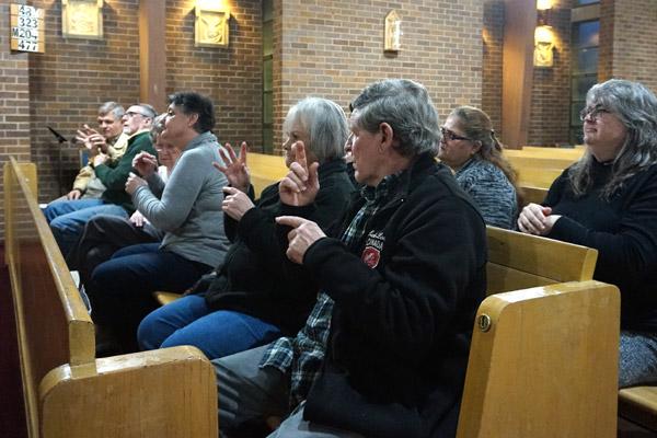 Members of the deaf community sign prayers during Mass Feb. 1 at St. Mary Church in North Little Rock. It was the fourth time the group has met for Mass celebrated completely in American Sign Language. (Aprille Hanson photo)
