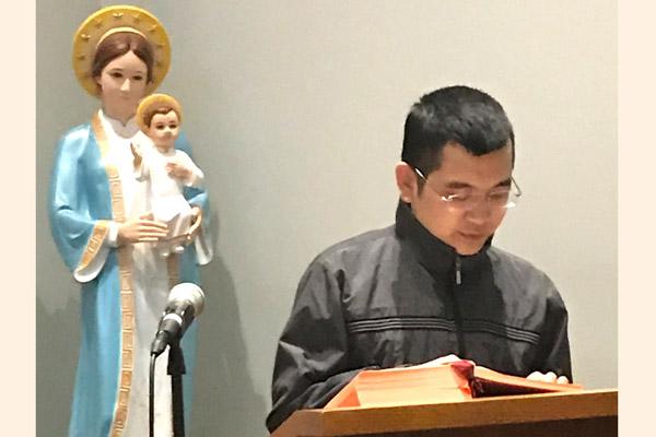 Seminarian Hong Nguyen reads during Mass at the House of Formation in Little Rock. The 15 seminarians are staying isolated, participating in online classes and no longer volunteering at parish ministries because of the threat of COVID-19. (Msgr. Scott Friend photo) 