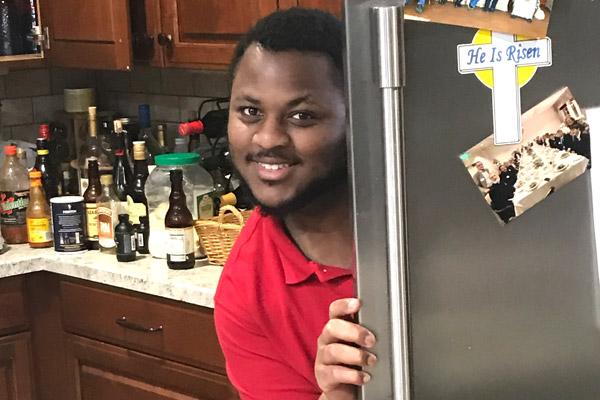 Duwan Booker flashes a smile by the refrigerator in the House of Formation on April 3. The men have been bonding through prayer and games. (Msgr. Scott Friend photo)