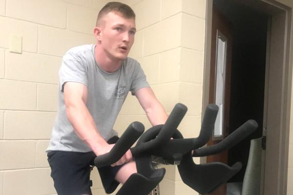 Seminarian Joseph Jones works out on an exercise bike at the House of Formation on April 2. The seminarians have been playing board games, watching movies, working out and praying during this time of isolation. (Courtesy House of Formation)
