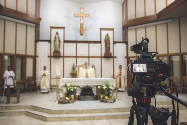 Pastor Father John Connell celebrates Mass at St. Raphael Church in Springdale on Holy Saturday, April 11, livestreaming on Facebook. (Travis McAfee photo)