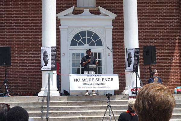 Rally organizer Marquis Hunt speaks to a crowd at Theressa Hoover United Methodist Church in Little Rock June 6 as he discussed the spirit of NFL player Colin Kaepernick’s protest on taking a knee against police brutality and explained how “white silence transmutates into violence against black bodies.” (Aprille Hanson photo)