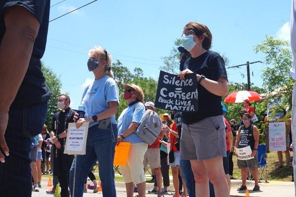 Pax Christi Little Rock members hold signs supporting the Black Lives Matter movement at the “Take a Knee - a Rally for Justice” June 6 in Little Rock. Pictured are Marian Paquette (right), Mary Hunt and Susi Blanco (back left). (Aprille Hanson photo)