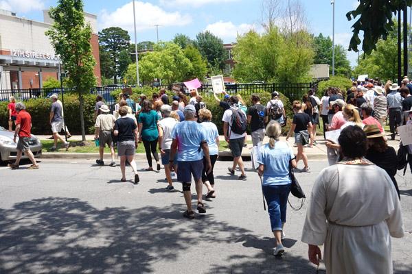 People of color and white allies walked parallel to the 12th Precinct police station where a letter was delivered to Little Rock Police Chief Keith Humphrey to encourage the dismantling of oppression and racism in law enforcement. Protestors then kneeled in a circle around the station. (Aprille Hanson photo)