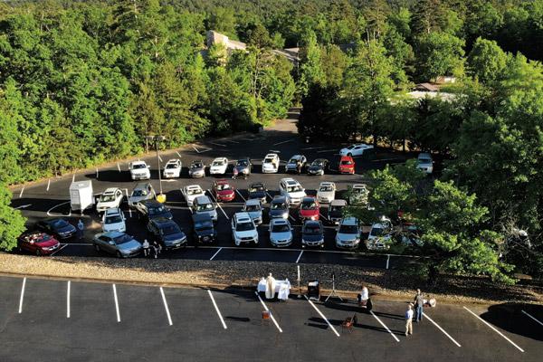 A drone captures pastor Father Bill Elser celebrating a parking lot Mass at Sacred Heart of Jesus Church in Hot Springs Village May 9. Since then, attendance has increased to the Saturday outdoor Mass. (Reneé Steinpreis photo, not available for sale)