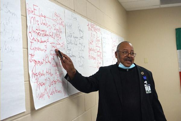 Father Warren Harvey points to the different perspectives expressed by seminarians and the Diocesan Council for Black Catholics on various symbols, including the confederate flag. (Aprille Hanson photo)
