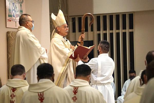 Bishop Anthony B. Taylor prays during the combined Chrism and Jubilarian Mass at Christ the King Church in Little Rock, as priests bow their heads in prayer. The Mass was closed to the public, but livestreamed. (Aprille Hanson photo)