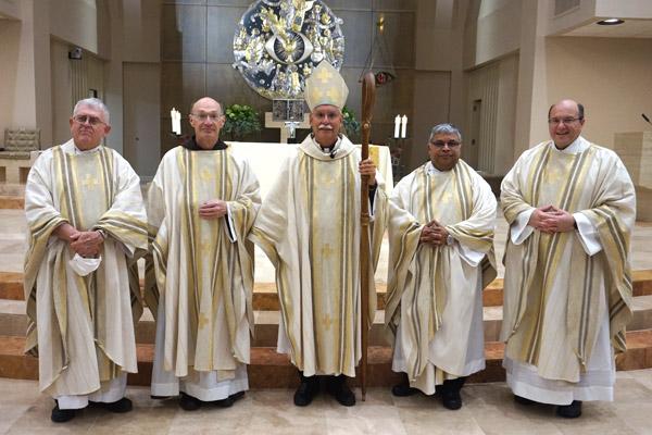 Jubilarian priests pose with Bishop Anthony B. Taylor after the Chrism/Jubilarian Mass Aug. 10 at Christ the King Church in Little Rock. Seen are Abbot Leonard Wangler, 50 years (left); Father Jerome Earley, 25 years; Father Amal Raju Punganoor Lourduswamy, 25 years; and Father Greg Luyet, 25 years. (Aprille Hanson photo)