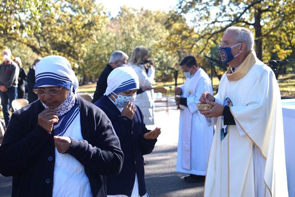 Missionaries of Charity receive Communion from Bishop Taylor during the All Souls’ Day Mass at Calvary Cemetery in Little Rock Nov. 2. (Aprille Hanson photo) 