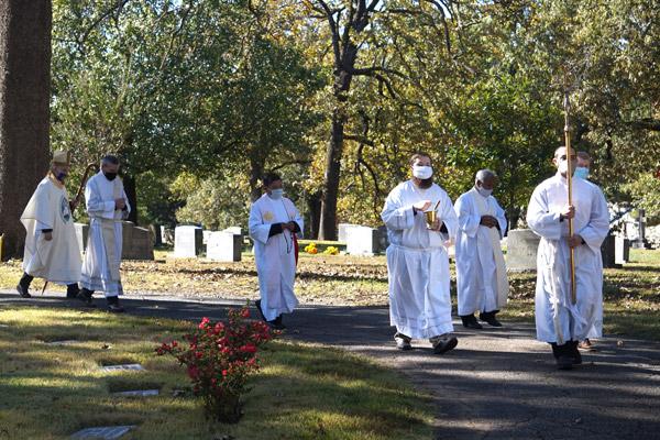 Bishop Taylor leads a rosary procession with Deacon John Hall, Fathers Jack Vu and Aby Abraham and seminarians Sam Stengel (carrying the cross), James Freeman (left) and Jonathan Semmler at Calvary Cemetery. (Aprille Hanson photo) 