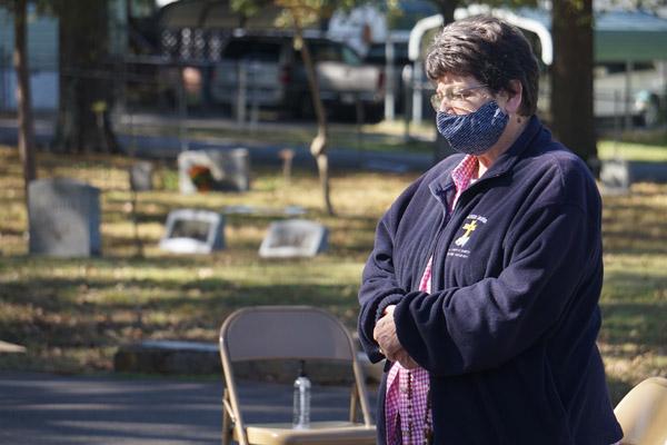 Debbie King, wife of Deacon Butch King who died Aug. 28, prays the rosary following the All Souls’ Day Mass at Calvary Cemetery Nov. 2. (Aprille Hanson photo) 