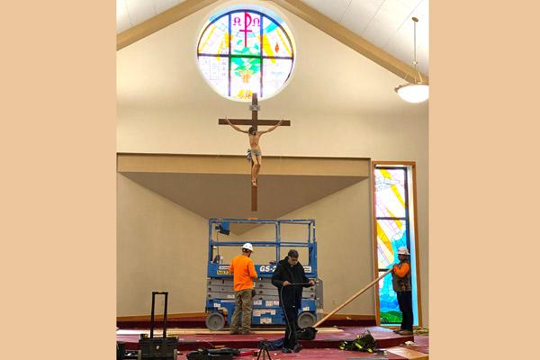 Father Alphonse Gollapalli, pastor of St. John Newman University Parish in Jonesboro, holds measuring tape as workers complete renovations to the sanctuary Oct. 26. The parish raised $300,000 for updates. (Brandon Weisenfels photo) 