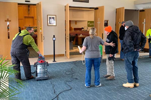Volunteers from the Knights of Columbus at St. Bernard Church in Bella Vista and from Bentonville gathered Feb. 17 to clean up water from frozen pipes that flooded the church and parish hall. (Don Schmutz photo)