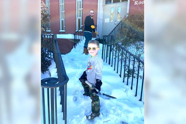 At St. Mary Church in Hot Springs, Bart Newman Jr. and his son Barrett, 5, shovel snow leading to the Carroll Room Feb. 19 so St. Mary’s Food Pantry could open. (Photo courtesy Bonnie Newman)