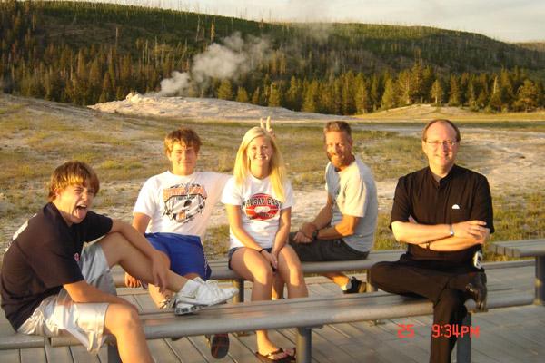 Father James West smiles with the Engel family, Austin (left), Zach, cousin Jennifer Moquin and Greg Engel at Yellowstone National Park in 2006. Father West, who felt like a brother to Brenda Engel, frequently traveled with them on family vacations. (Courtesy Brenda Engel)