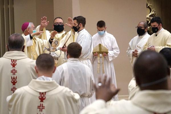 Bishop Anthony B. Taylor and priests of the diocese extend their hands and bless the sacred chrism oil during the annual Chrism Mass at Christ the King Church in Little Rock March 29. (Aprille Hanson Spivey photo)