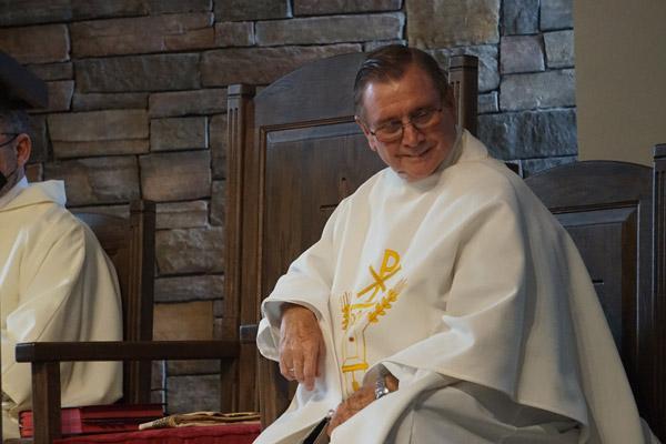 Father Ernie Hardesty, who has been pastor of St. Leo the Great University Parish in Russellville for 25 years, smiles during the dedication Mass April 14. (Aprille Hanson Spivey photo) 
