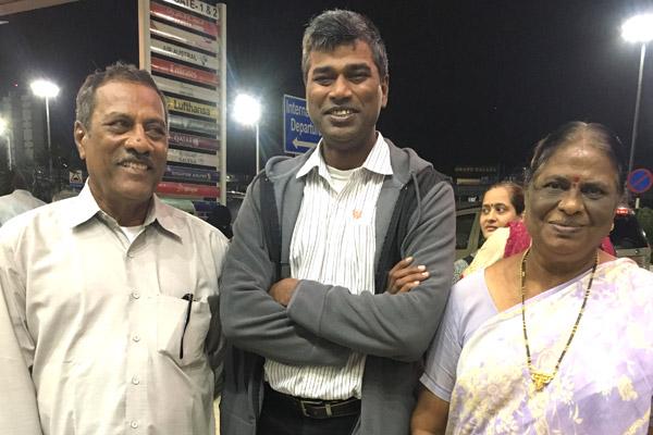 Father Balaraju Desam (center) smiles with his parents Desam Vincent and Arogya Mary at the airport in Chennai, India, on a September 2019 visit home. (Photo courtesy Father Balaraju Desam)