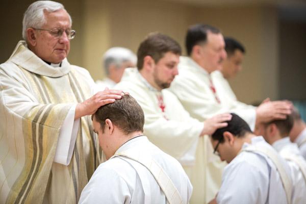 Msgr. J. Gaston Hebert lays hands on Father Martin Siebold during his priestly ordination in 2017, praying for the newly ordained. The tradition is rooted in the Bible. (Travis McAfee photo, Arkansas Catholic file)