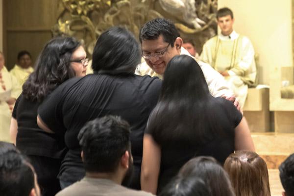 Father Mario Jacobo blesses his family from Georgia during his priestly ordination Mass in 2016. At the end of Mass, the newly ordained priests typically bestow a first blessing on family or friends. (Bob Ocken photo, Arkansas Catholic file)